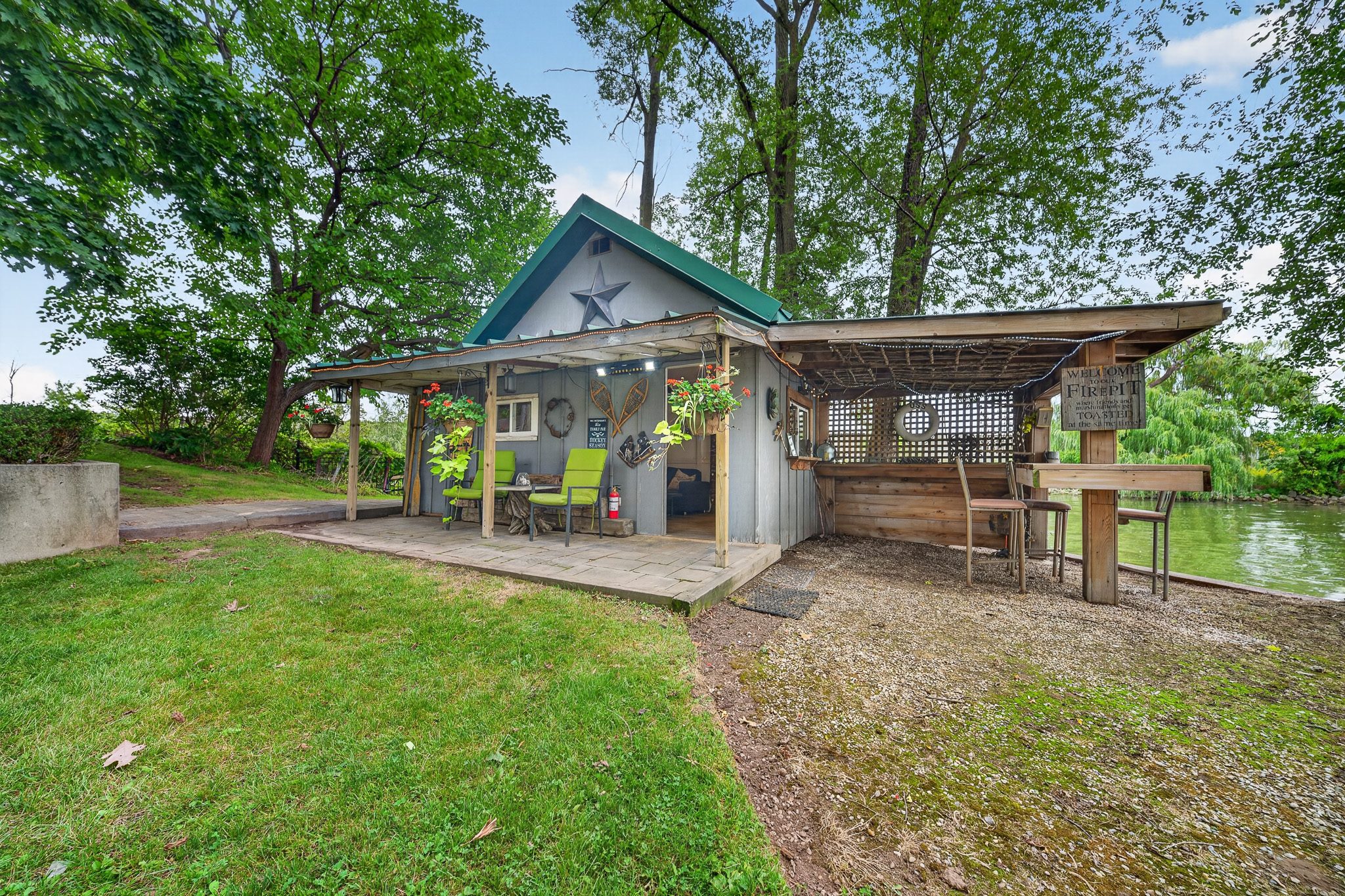 The bunkie with its covered porch near the water