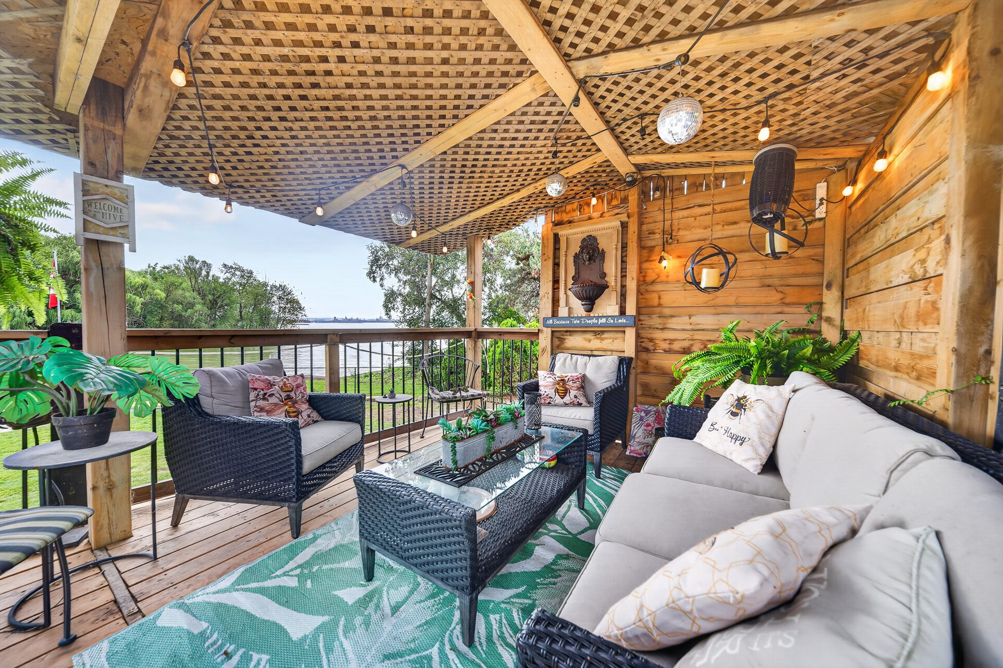 The covered lounge on the deck with the water behind