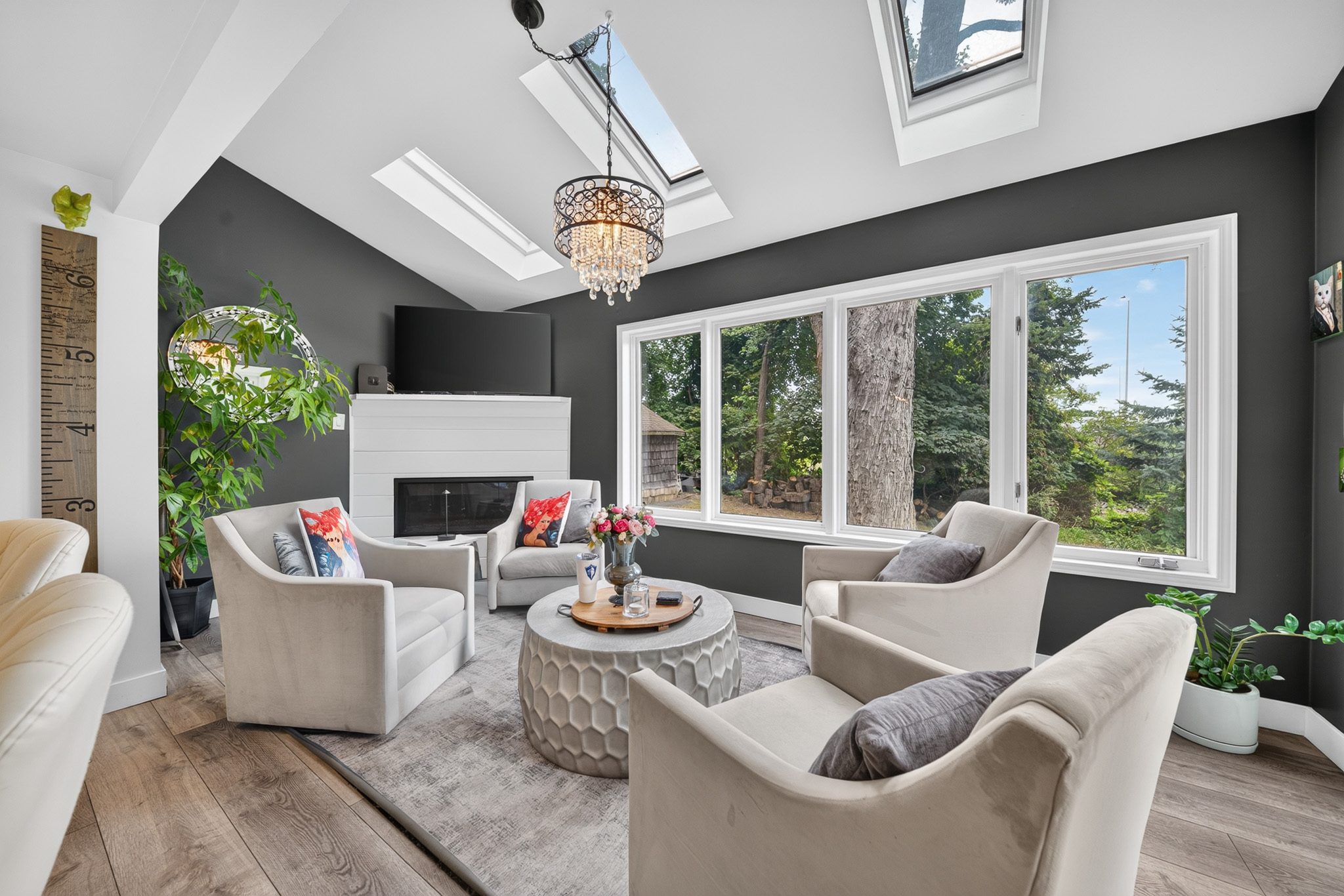 The family room with skylights, a fireplace and garden views