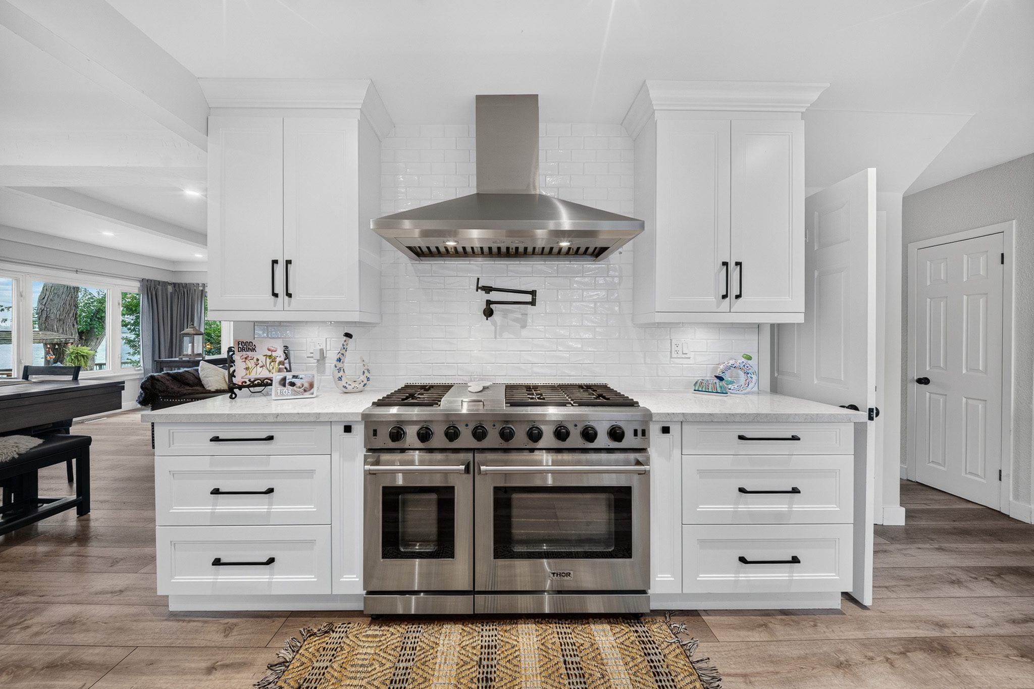 The kitchen with its double-oven chef's range and hood