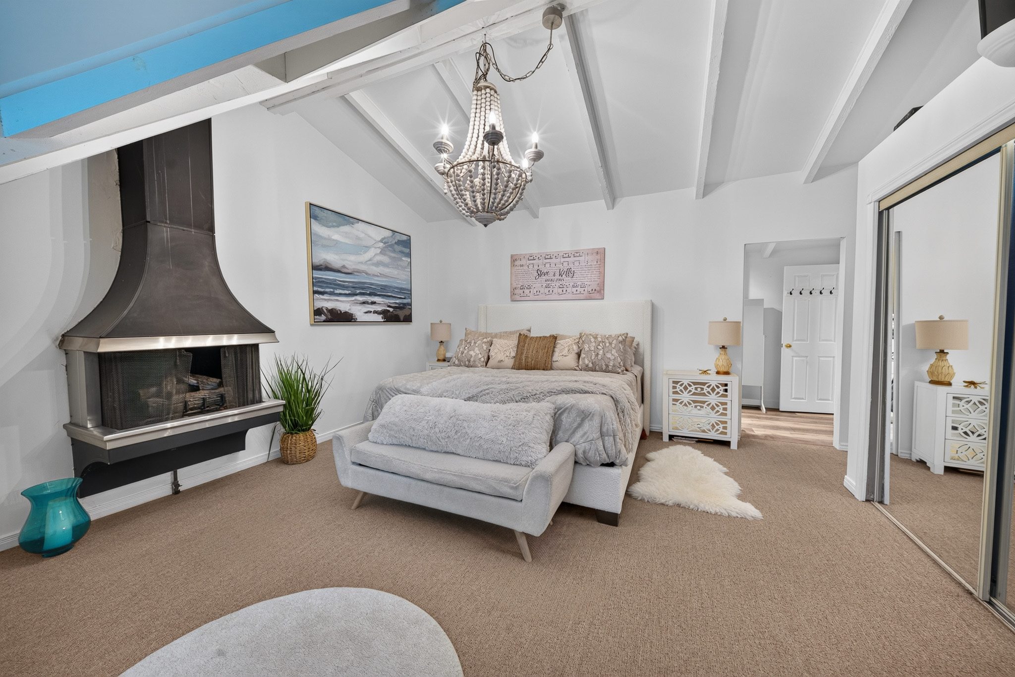 The primary suite with its fireplace and vaulted ceiling