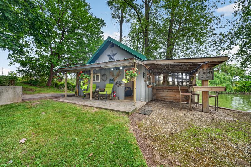 The bunkie with its covered porch near the water
