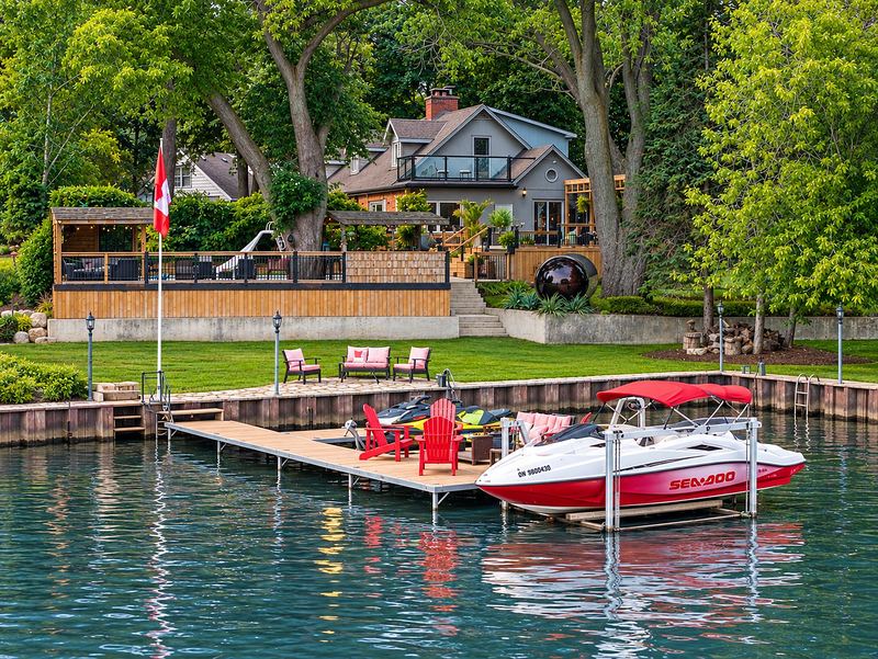 The dock with its lifts, the boats and the house above the lawn