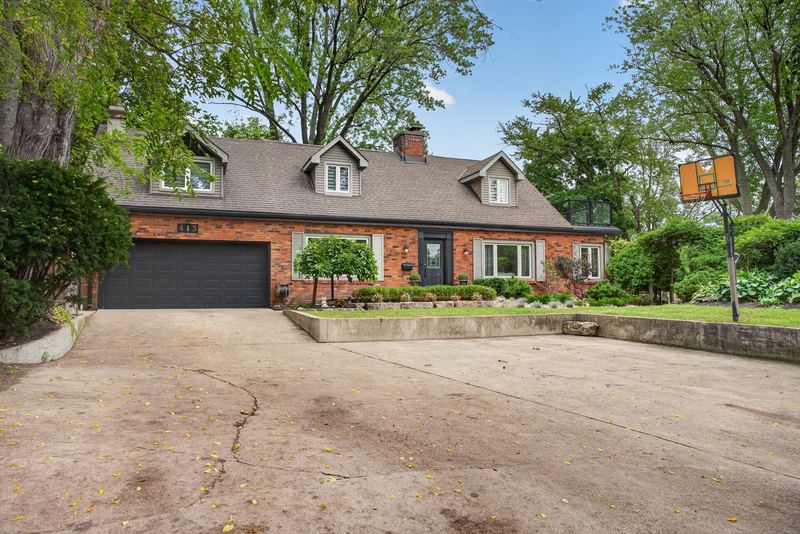 The brick front of the house and the wide drive