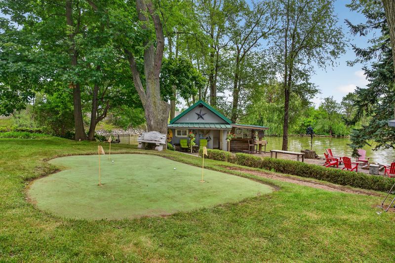 The putting green with the bunkie and the water beyond