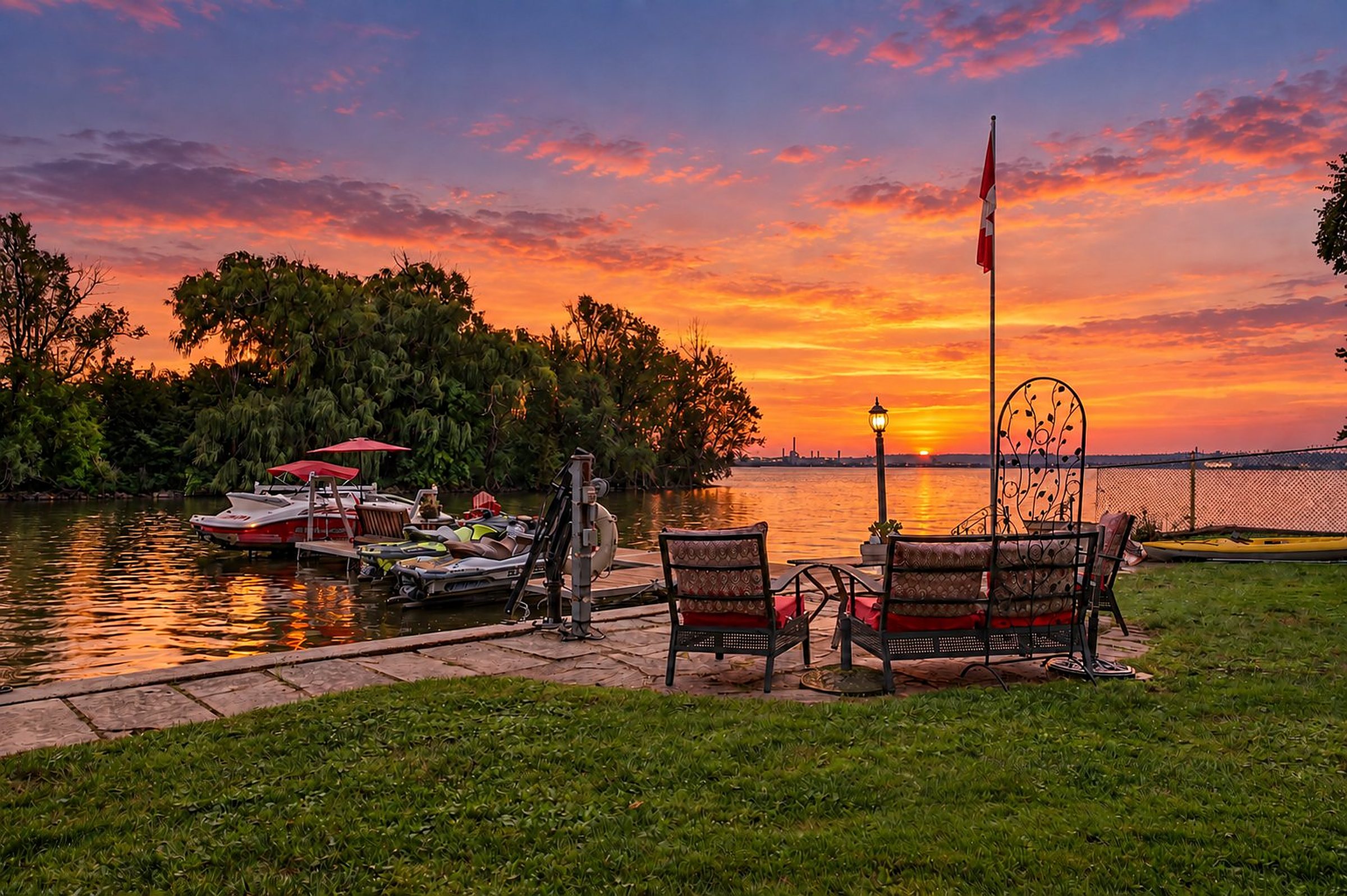 The sun setting over the bay from the seating area at the dock (virtual twilight)